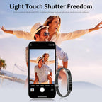 Smartphone with camera app open showing a photo of a couple, with a Actyraxer Tracker Bracelet on a beach background.