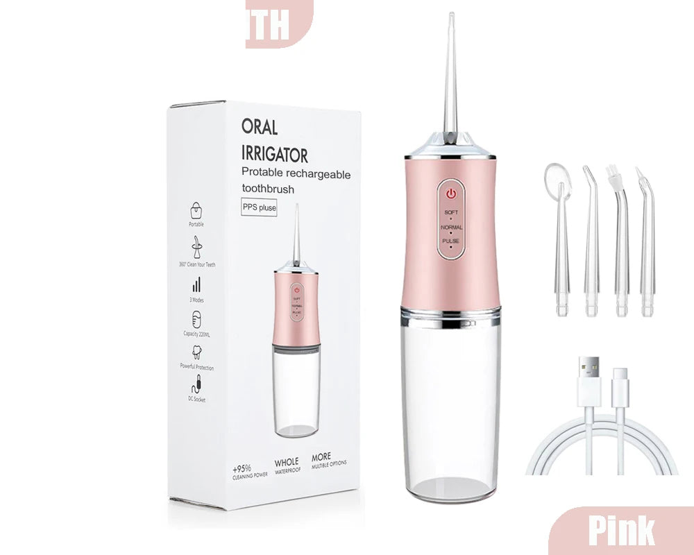 AquaBriska Water Flosser shown with its retail box, multiple nozzle tips, and a charging cable on a clean white background. The device has a metallic pink upper body, a clear water tank, and a transparent nozzle.