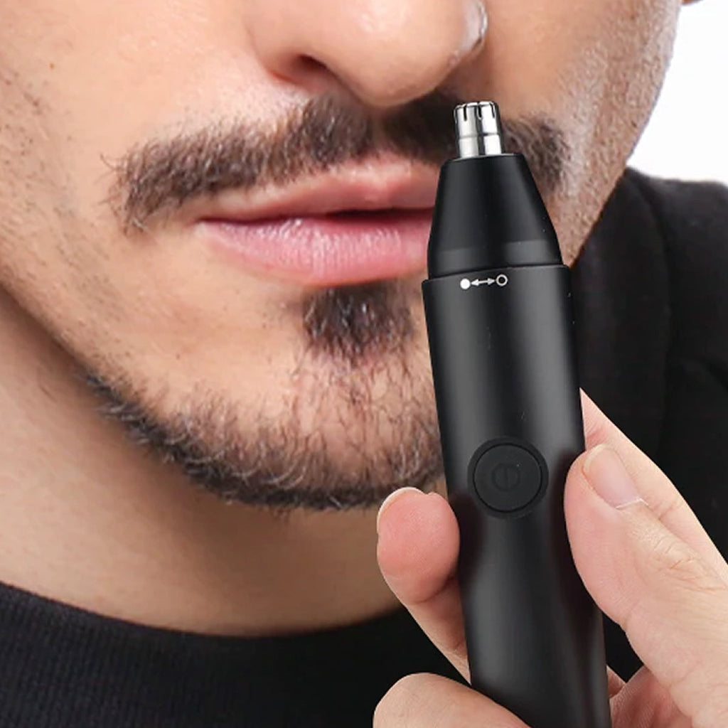 Person using a black  ClipCrazie Nasal Hair Trimmer on their nose.
