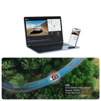 A laptop and smartphone displaying a GPS tracking with DashyLynk and video monitoring software interface, with an aerial road-map visualization below showing a car's real-time location and speed on a forest road.