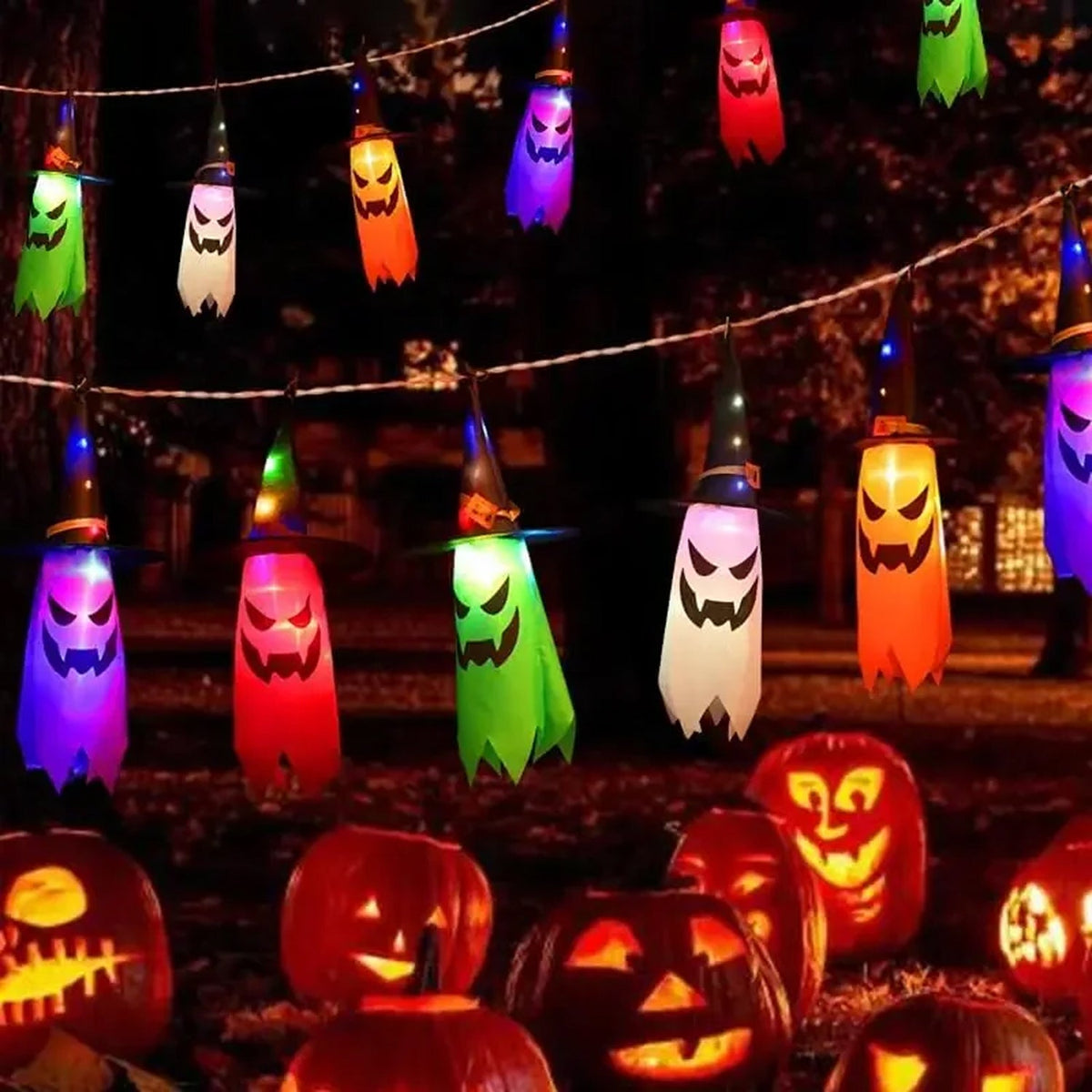 HexWitchi Jack O Lantern with colorful ghost shapes and carved pumpkins in a dark outdoor setting.