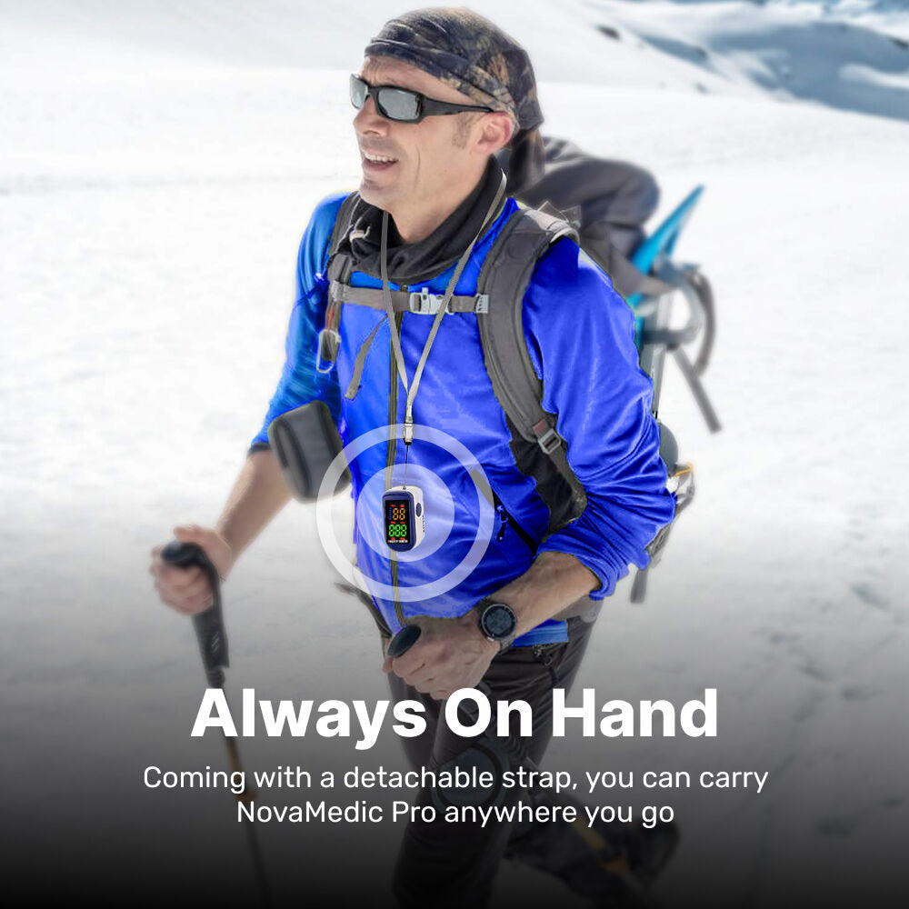 Man hiking in snowy landscape with OxiLuny v2 Pulse Oximeter device on strap