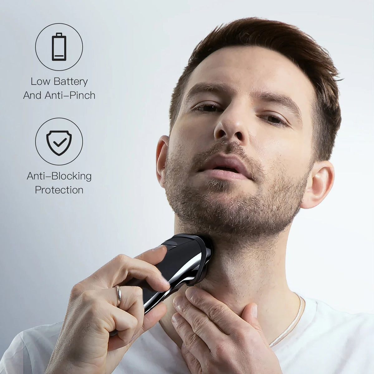 A man using a black and RazoRixer Electric Razor on his neck, with two feature callout icons on the left reading 'Low Battery And Anti-Pinch' and 'Anti-Blocking Protection'.