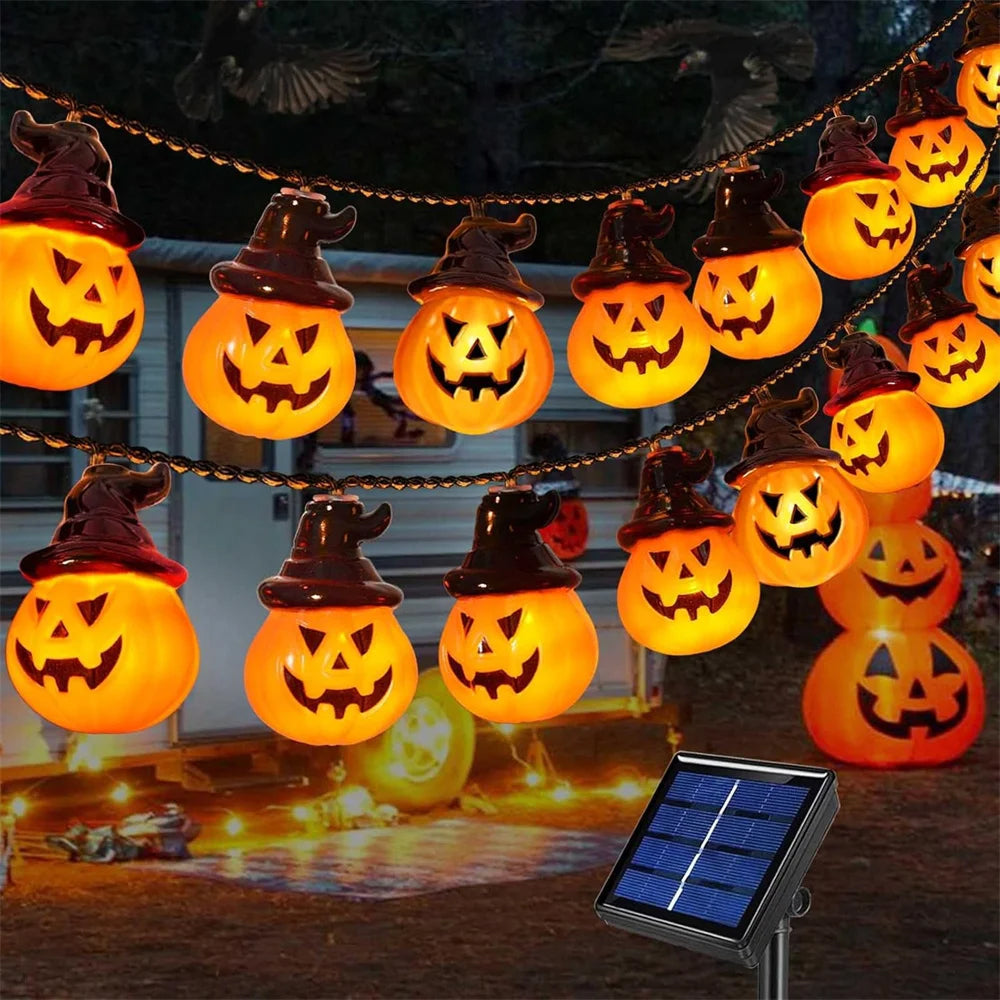 Halloween Sunpikoex Solar Pumpkin Lights  featuring glowing jack-o'-lantern pumpkins wearing witch hats, shown hanging outdoors at night with a small solar panel in the foreground.