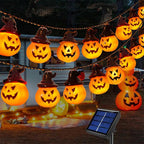 Halloween Sunpikoex Solar Pumpkin Lights  featuring glowing jack-o'-lantern pumpkins wearing witch hats, shown hanging outdoors at night with a small solar panel in the foreground.