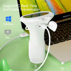 White ZoomiWiz HD Kids Microscope on a green surface with a laptop in the background, featuring Windows and Mac logos.